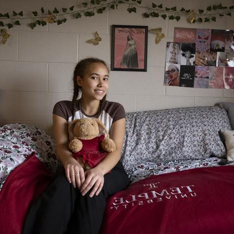 student posing in her dorm room.